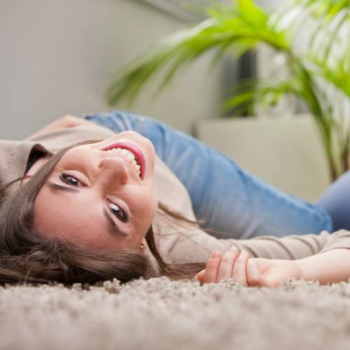 woman laying on carpet